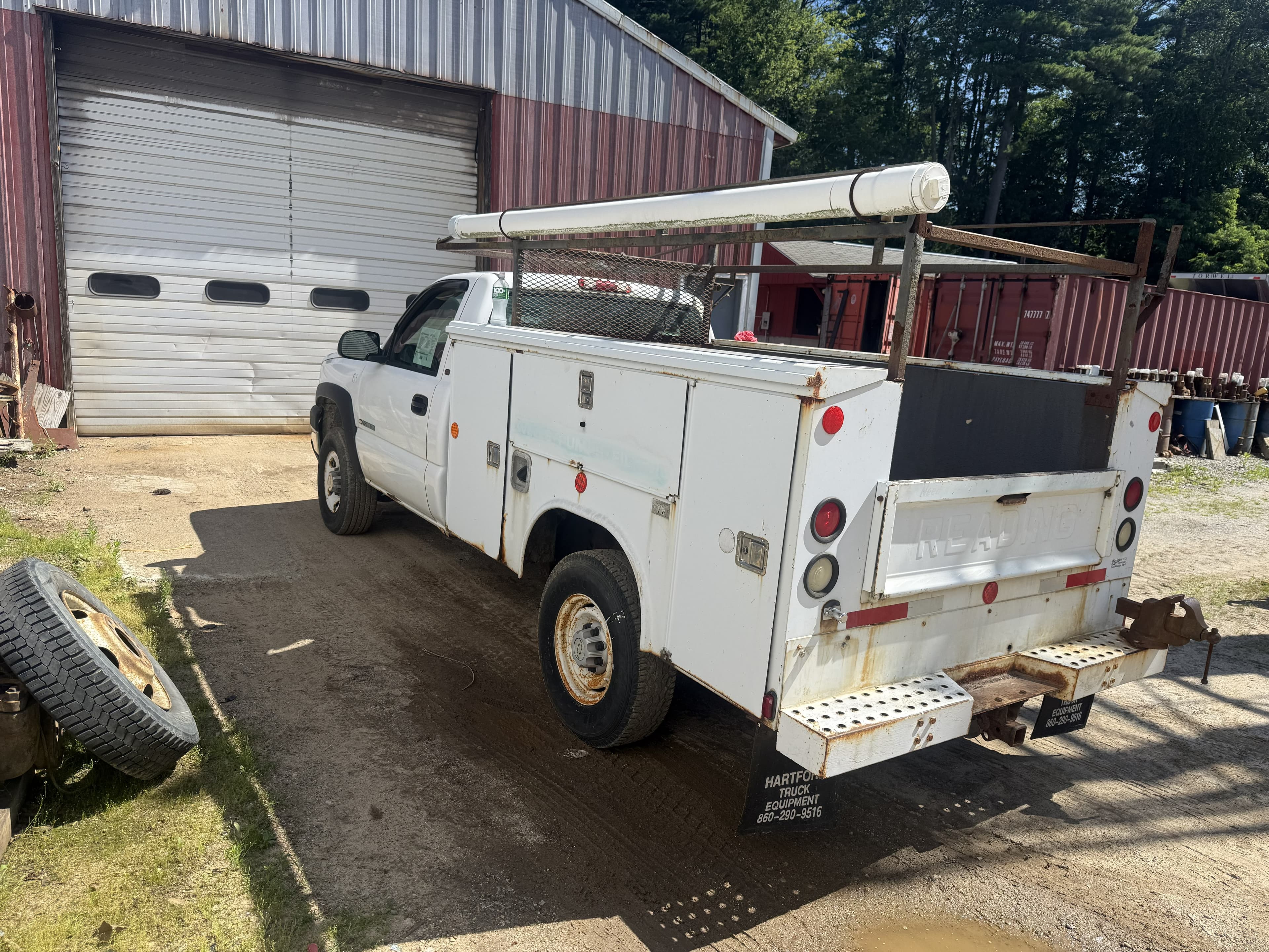 Limitless Auto service truck in the shop yard, pole barn in the background